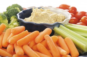 Closeup of a vegetable platter with Greek style hummus